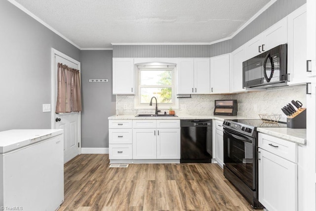 415 Crestview Dr, Thomasville, NC 27360 - kitchen with black appliances, dark wood-style flooring, tasteful backsplash, ornamental molding, and light stone counters