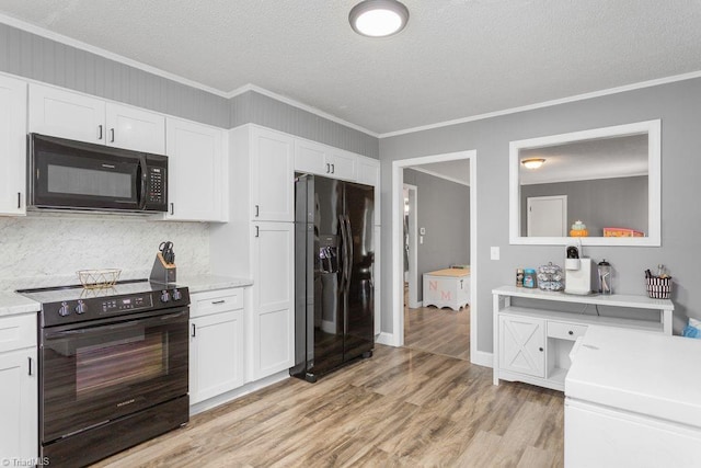 415 Crestview Dr, Thomasville, NC 27360 - kitchen featuring black appliances, crown molding, white cabinets, light wood-type flooring, and a textured ceiling
