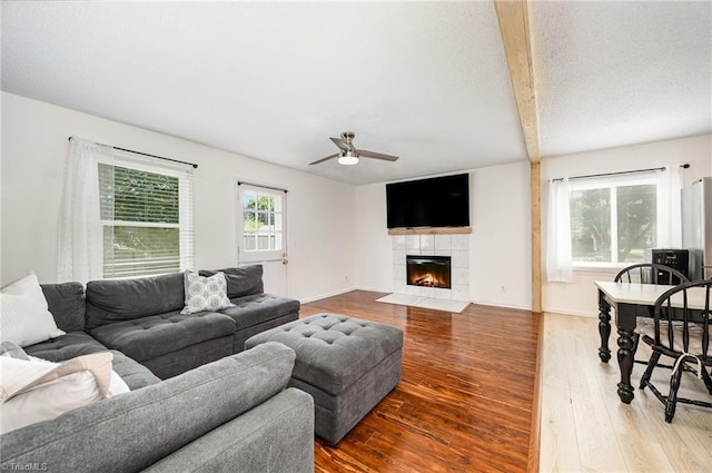 1018 Sequoia Dr, Lewisville, NC 27023 - living area featuring wood finished floors, ceiling fan, a tile fireplace, and beam ceiling