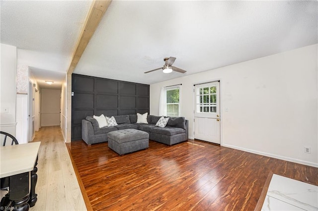 1018 Sequoia Dr, Lewisville, NC 27023 - living room featuring hardwood / wood-style floors, ceiling fan, a decorative wall, and beam ceiling