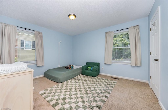 1018 Sequoia Dr, Lewisville, NC 27023 - carpeted bedroom featuring baseboards and a textured ceiling
