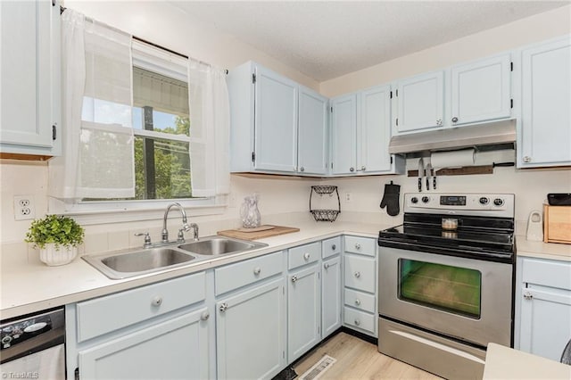1018 Sequoia Dr, Lewisville, NC 27023 - kitchen with stainless steel electric range, under cabinet range hood, light countertops, light wood-style flooring, and dishwashing machine