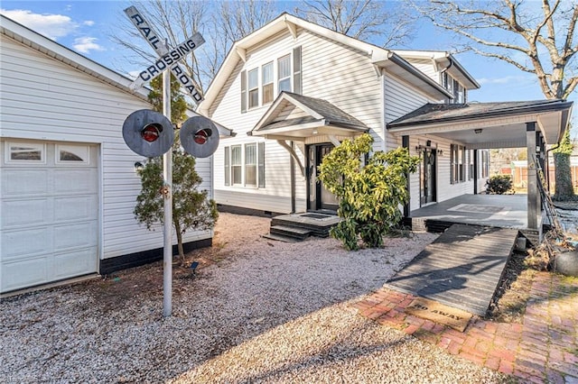 view of front of house featuring a porch and a garage