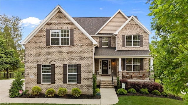 4420 Bonnie Loch Dr, Burlington, NC 27215 - view of front facade featuring brick siding, covered porch, and roof with shingles
