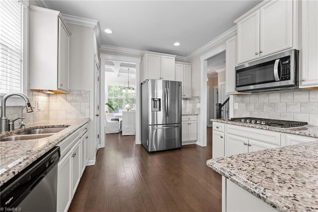 4420 Bonnie Loch Dr, Burlington, NC 27215 - kitchen with stainless steel appliances, a sink, crown molding, dark wood-type flooring, and light stone countertops