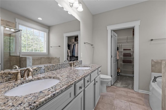 4420 Bonnie Loch Dr, Burlington, NC 27215 - bathroom with a tub, toilet, double vanity, a spacious closet, and a stall shower