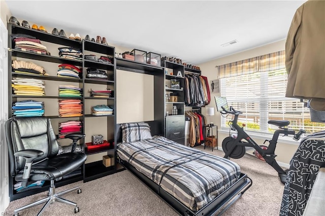 bedroom featuring carpet and baseboards