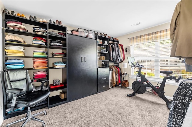 exercise room featuring carpet and baseboards