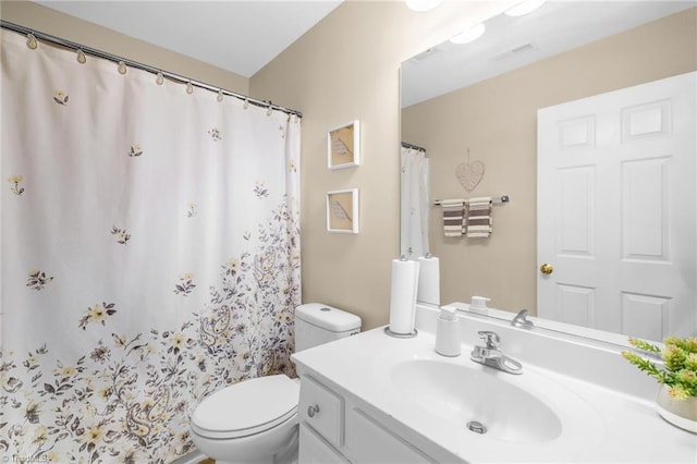 bathroom with toilet and vanity