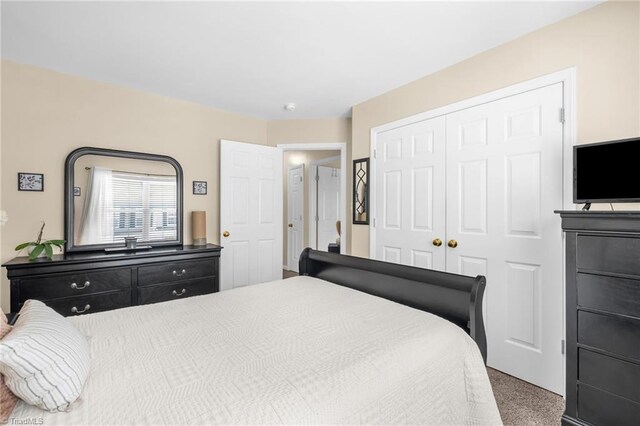 carpeted bedroom with a closet