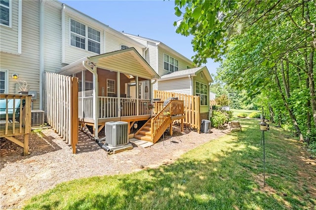 back of house featuring a sunroom, a deck, and cooling unit