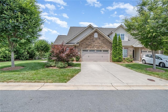 5207 York Place Ct, Walkertown, NC 27051 - view of front of home featuring concrete driveway, a front lawn, stone siding, and a garage