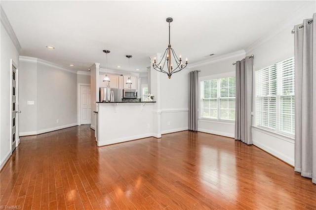 5207 York Place Ct, Walkertown, NC 27051 - unfurnished living room featuring a chandelier, dark wood-style floors, recessed lighting, and ornamental molding
