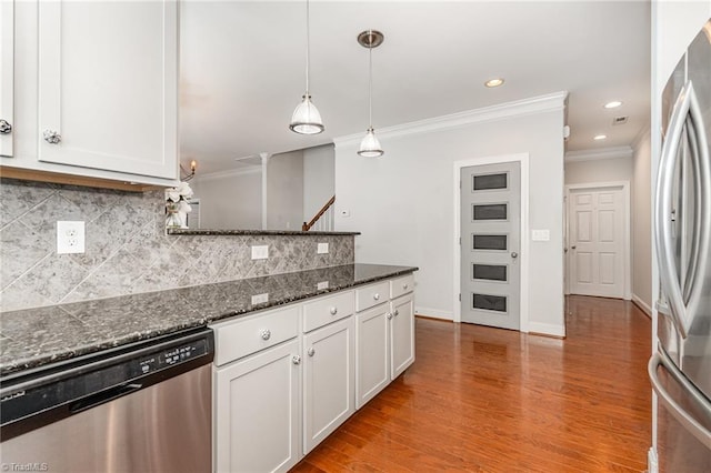 5207 York Place Ct, Walkertown, NC 27051 - kitchen featuring stainless steel appliances, ornamental molding, white cabinetry, a peninsula, and decorative backsplash