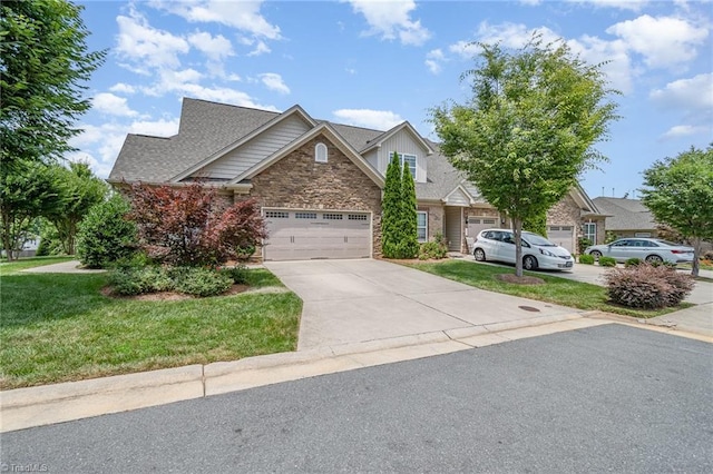 5207 York Place Ct, Walkertown, NC 27051 - view of front of home featuring stone siding, concrete driveway, a front lawn, and an attached garage