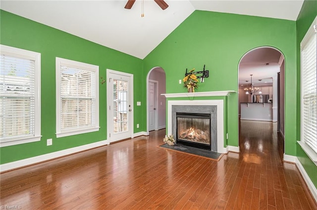 5207 York Place Ct, Walkertown, NC 27051 - unfurnished living room featuring ceiling fan, a fireplace with flush hearth, vaulted ceiling, and wood finished floors