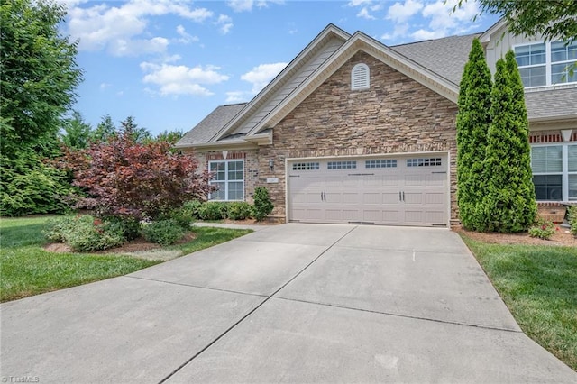5207 York Place Ct, Walkertown, NC 27051 - view of front of home featuring a garage, driveway, stone siding, and a shingled roof