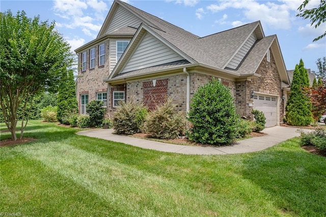 5207 York Place Ct, Walkertown, NC 27051 - traditional-style house featuring an attached garage, a front yard, a shingled roof, concrete driveway, and brick siding