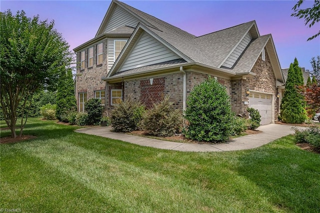 5207 York Place Ct, Walkertown, NC 27051 - traditional home with an attached garage, a front lawn, roof with shingles, concrete driveway, and brick siding