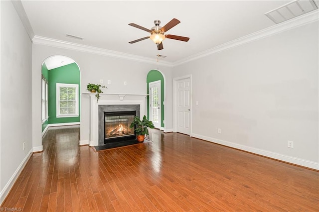 5207 York Place Ct, Walkertown, NC 27051 - unfurnished living room with ceiling fan, a premium fireplace, ornamental molding, wood finished floors, and arched walkways