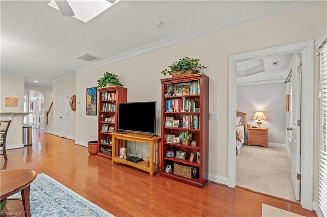 living room with hardwood / wood-style floors and ornamental molding