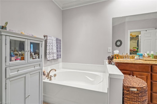 bathroom featuring a bathtub, crown molding, and vanity