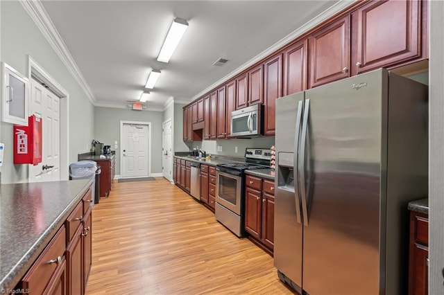 kitchen with light hardwood / wood-style floors, sink, ornamental molding, and appliances with stainless steel finishes