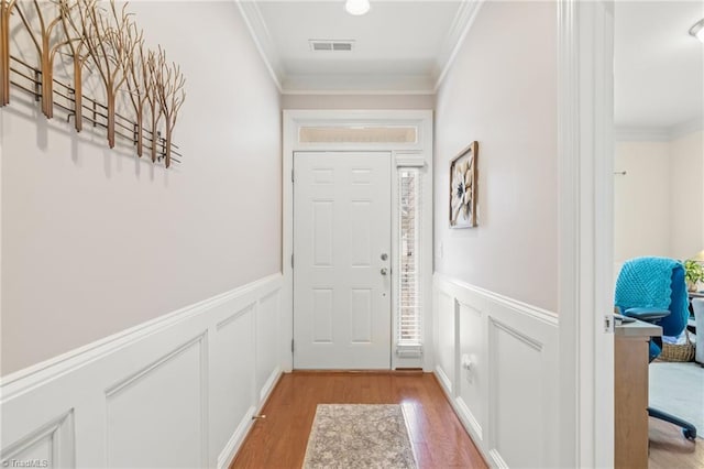 doorway featuring light hardwood / wood-style floors and crown molding