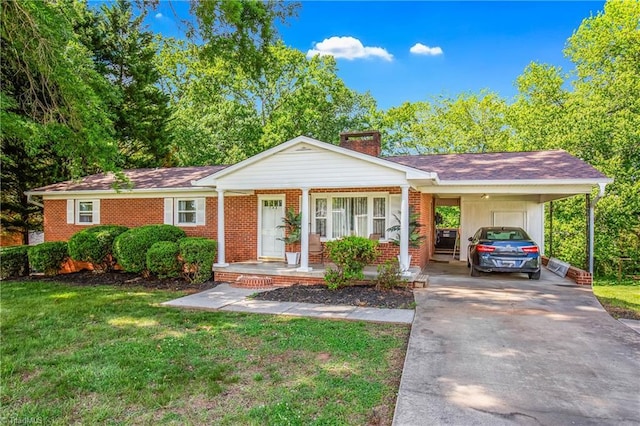 single story home with a chimney, a porch, driveway, a front lawn, and brick siding