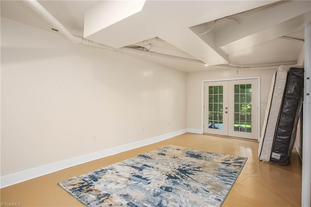 empty room with french doors and baseboards