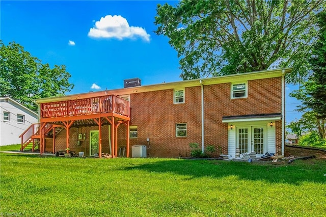 back of property with french doors, a wooden deck, central air condition unit, and brick siding