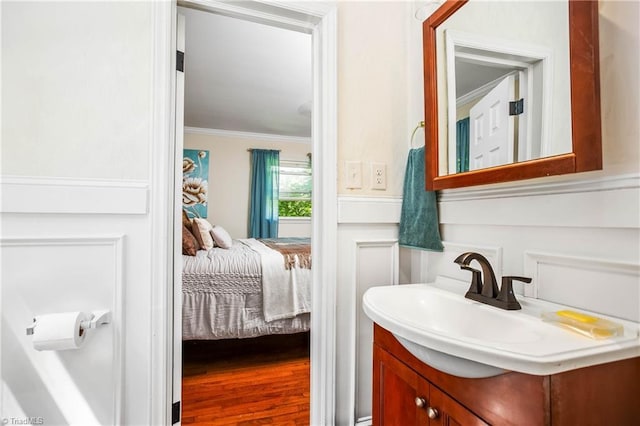 ensuite bathroom with crown molding and vanity