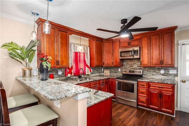 kitchen featuring appliances with stainless steel finishes, ornamental molding, a sink, a peninsula, and tasteful backsplash