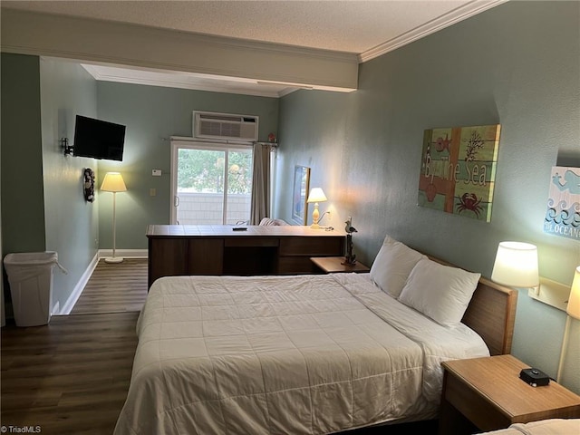 bedroom with crown molding, hardwood / wood-style floors, and a wall unit AC