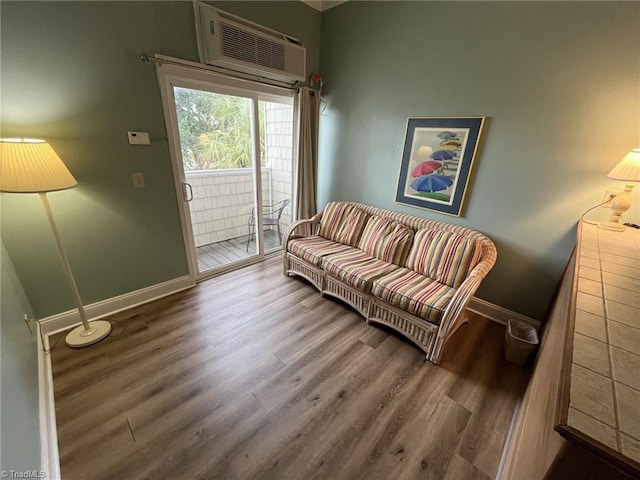 living room with wood-type flooring and an AC wall unit