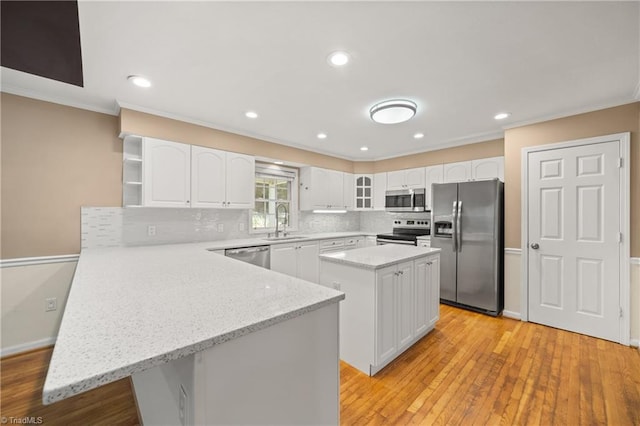4028 Lofter Ct, Pfafftown, NC 27040 - kitchen featuring appliances with stainless steel finishes, a peninsula, open shelves, ornamental molding, and white cabinets