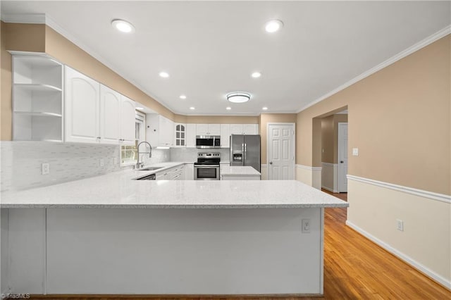 4028 Lofter Ct, Pfafftown, NC 27040 - kitchen featuring appliances with stainless steel finishes, a peninsula, crown molding, tasteful backsplash, and open shelves