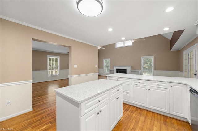4028 Lofter Ct, Pfafftown, NC 27040 - kitchen featuring open floor plan, ornamental molding, light wood-style floors, a fireplace, and recessed lighting