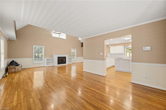 4028 Lofter Ct, Pfafftown, NC 27040 - unfurnished living room with ceiling fan, light wood-style flooring, a fireplace, and crown molding