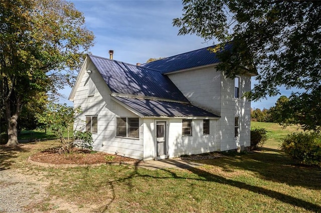 back of property featuring a lawn