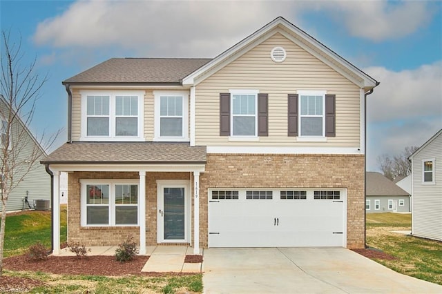 view of front of house featuring central air condition unit, a front lawn, and a garage