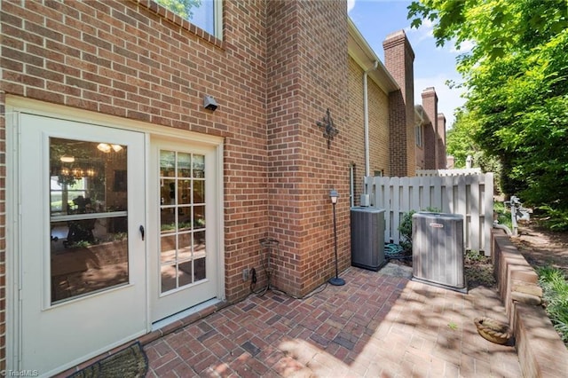 view of patio with cooling unit and fence
