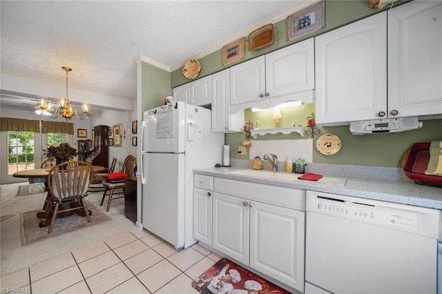 kitchen featuring white appliances, a sink, a chandelier, white cabinetry, and light countertops