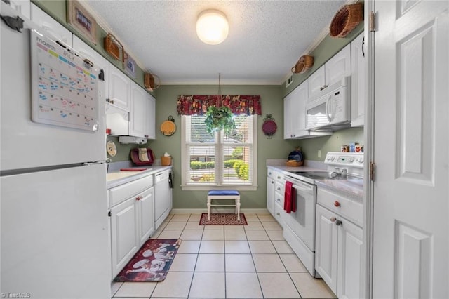 kitchen featuring white appliances, white cabinetry, light countertops, a textured ceiling, and light tile patterned flooring