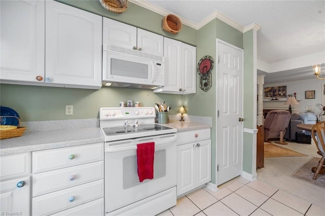 kitchen with white appliances, white cabinetry, light countertops, crown molding, and light tile patterned floors