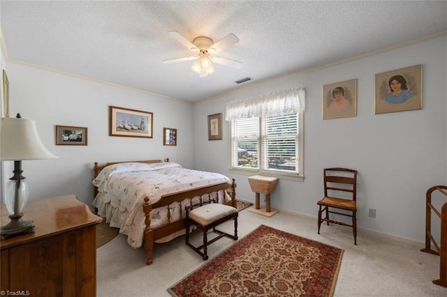 bedroom featuring light carpet, crown molding, ceiling fan, and a textured ceiling