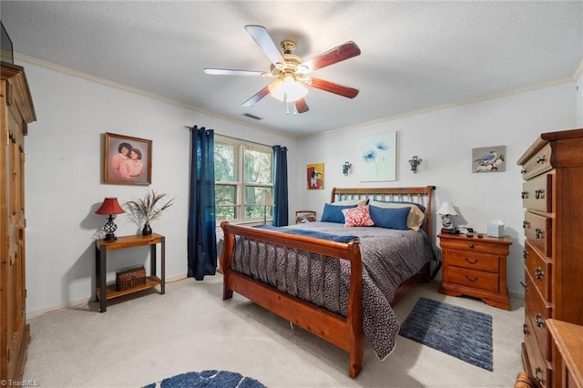 bedroom featuring crown molding, light carpet, a textured ceiling, ceiling fan, and baseboards