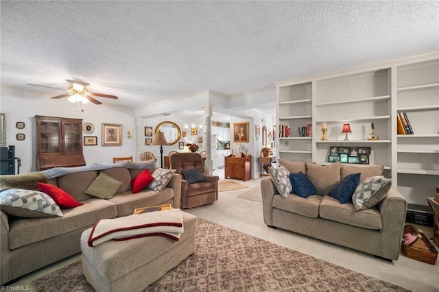 living area featuring a textured ceiling, carpet flooring, and a ceiling fan