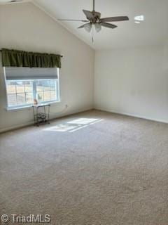 carpeted empty room featuring a ceiling fan and high vaulted ceiling