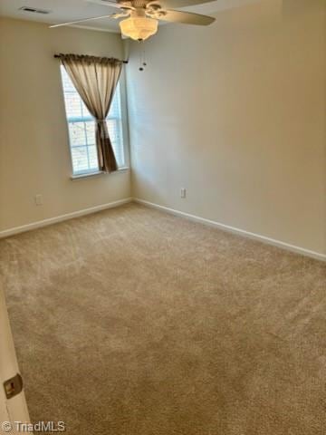 unfurnished room featuring baseboards, ceiling fan, visible vents, and light colored carpet